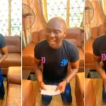 Man Filmed Praying fervently On His Nigerian Passport In Order To Be Granted US, UK Visa [VIDEO] | Daily Report Nigeria